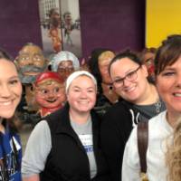 Group of alumni smiling at parade company